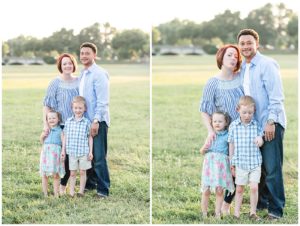 family of 4 in a field smiling and laughing