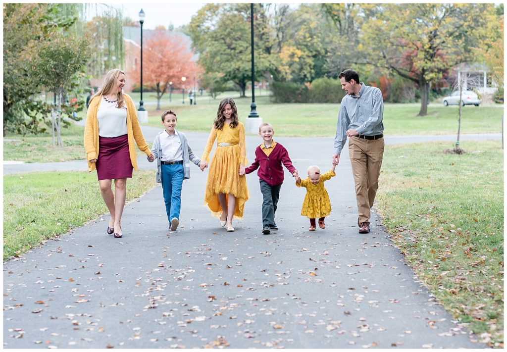 a family of 6 walks together for fall family pictures